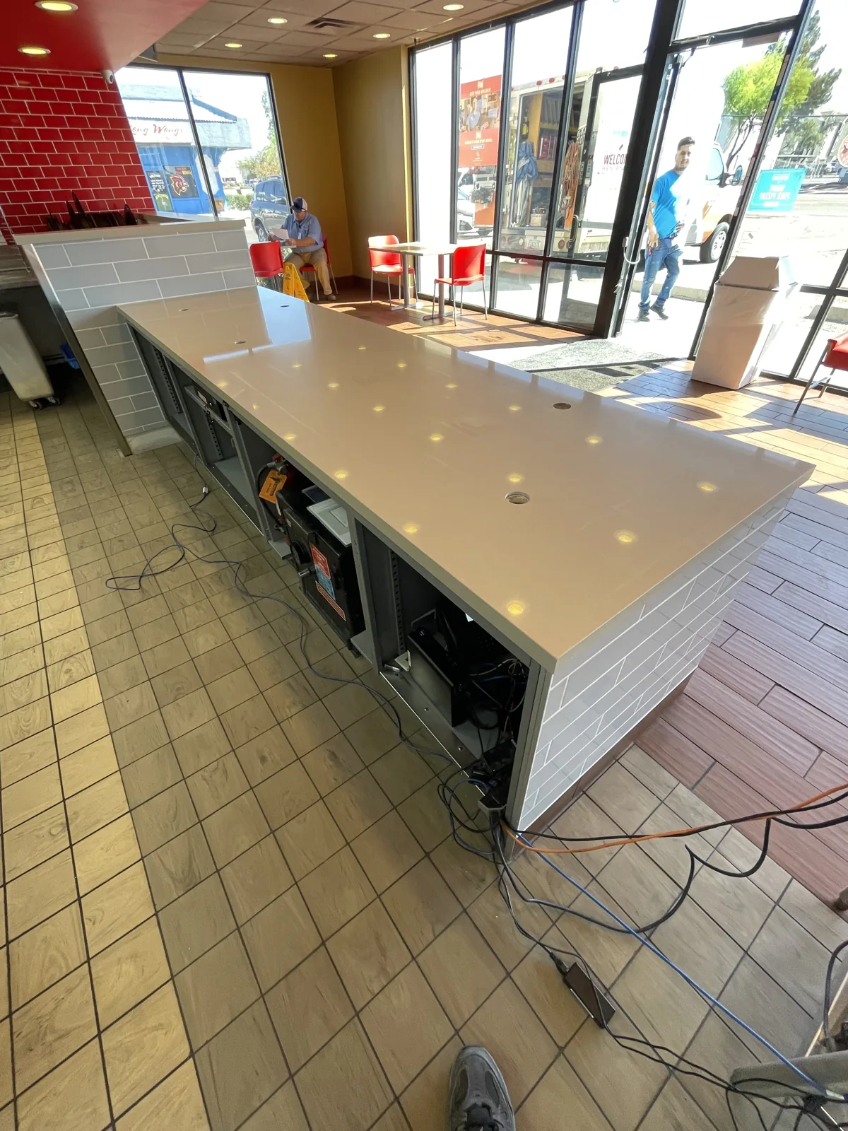 Commercial checkout counter with integrated lighting and tile work