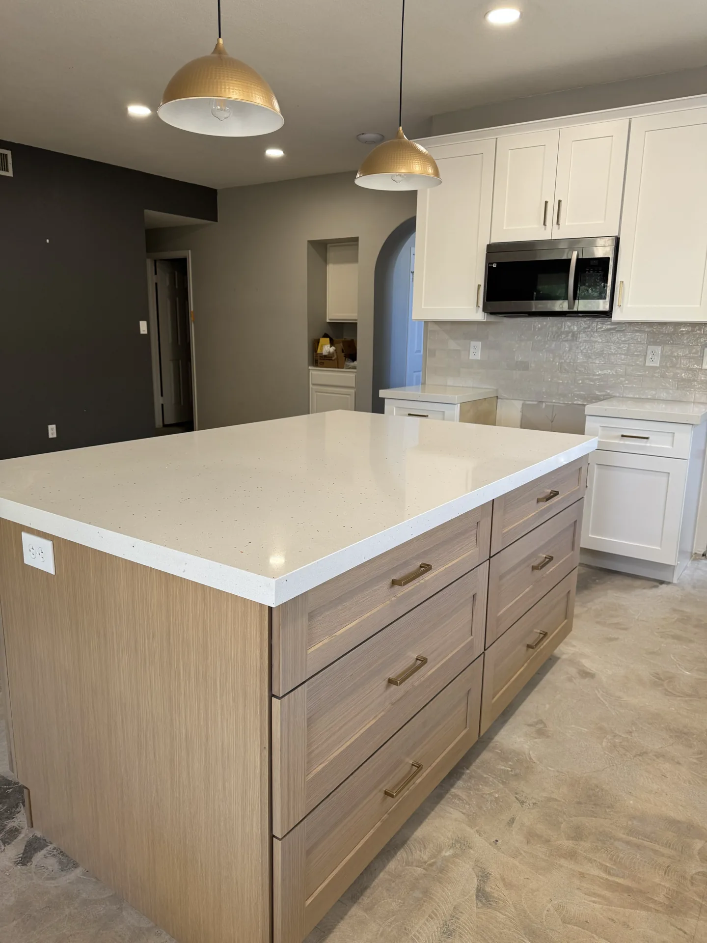 Kitchen remodel with a quartz-topped island and light wood cabinetry by Orange Cactus Remodeling, serving Ahwatukee, AZ