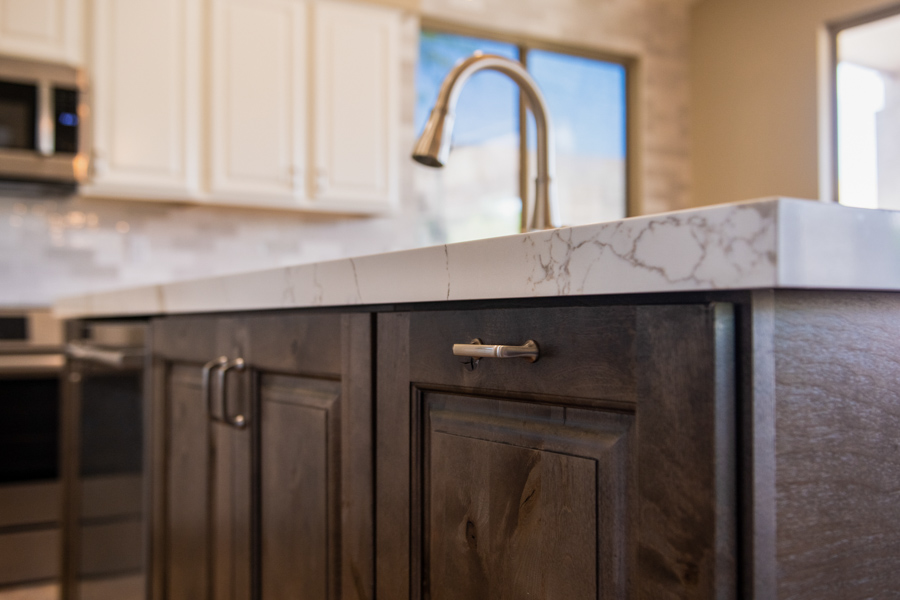 Kitchen remodel with stained wood cabinetry, a quartz countertop, and a brushed-gold faucet by Orange Cactus Remodeling, serving Ocotillo, Chandler, AZ