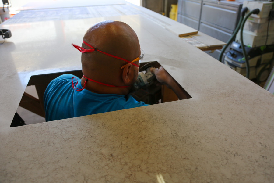 An Orange Cactus Remodeling craftsman cutting the sink opening in a countertop at the company's shop