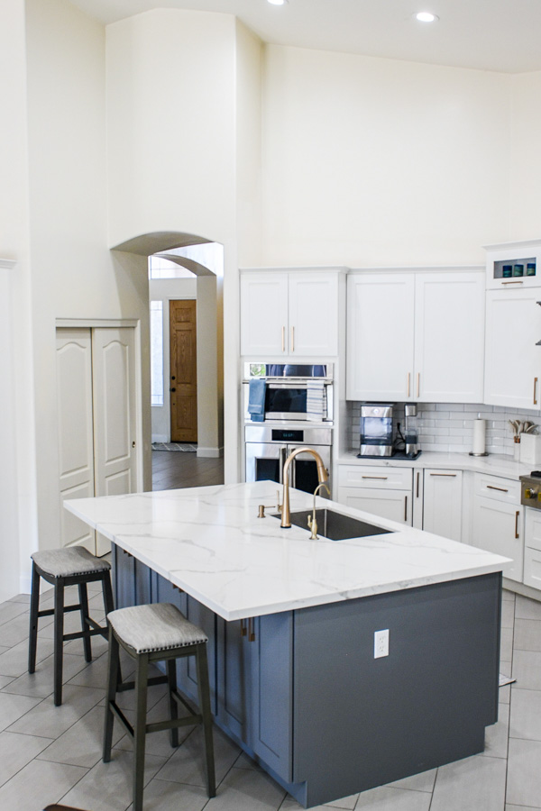 Kitchen remodel with white cabinets and a navy island with seating, by Orange Cactus Remodeling, serving Ahwatukee, AZ