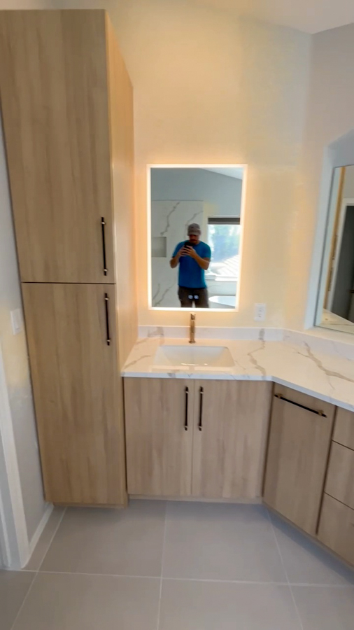 Custom vanity with quartz countertop and storage solutions