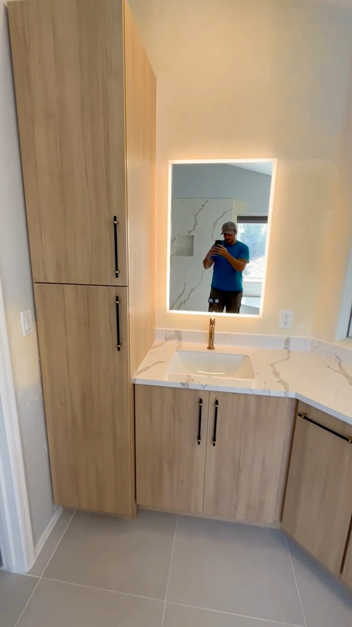 Bathroom vanity with wood-tone cabinetry and an LED mirror, remodeled by Orange Cactus Remodeling, serving Dobson Ranch, Mesa, AZ