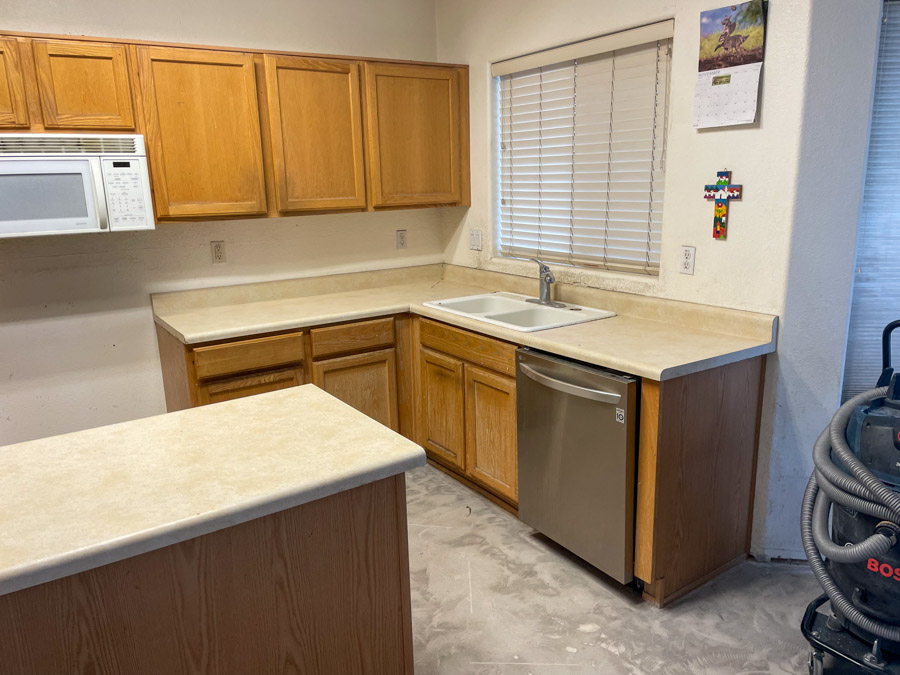 A dated builder-grade oak kitchen before an Orange Cactus remodel — the kind of layout common in 2000s East Valley homes