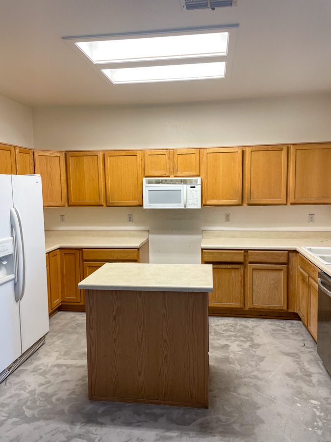 A dated oak kitchen with white appliances before an Orange Cactus remodel, the kind of kitchen common in older East Valley homes