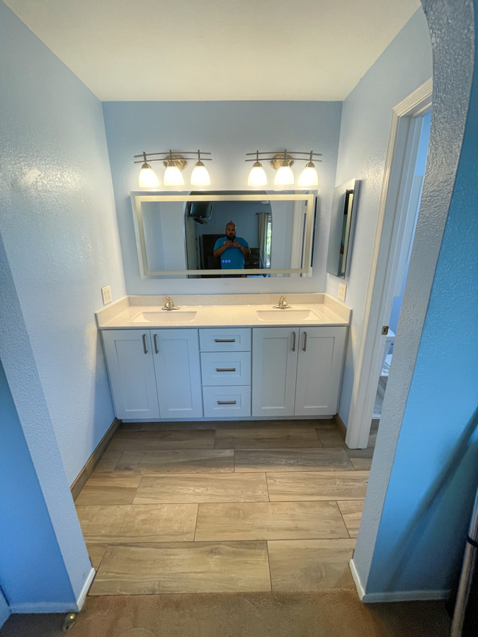 Modern bathroom vanity remodel with quartz top and updated matte black faucet