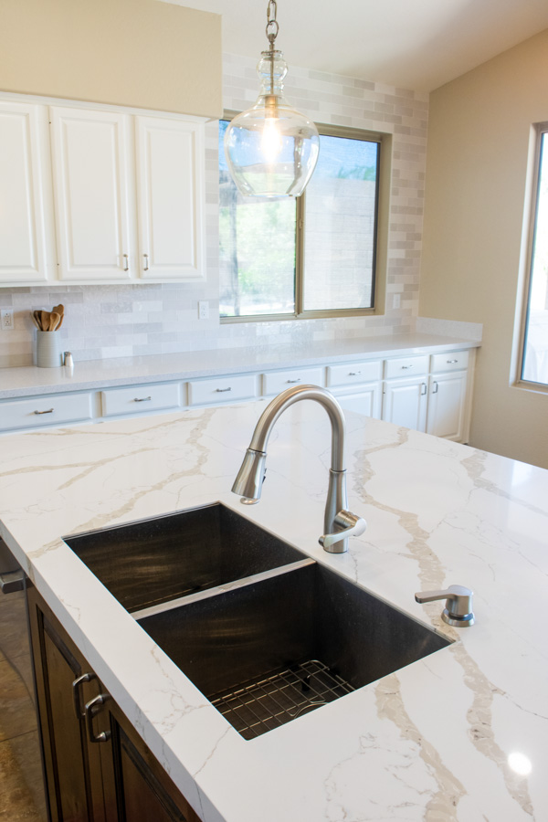 Kitchen remodel with a marble-look quartz counter, a black undermount double sink, and white cabinetry by Orange Cactus Remodeling, serving Ocotillo, Chandler, AZ