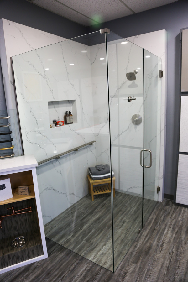 Low-maintenance shower panel system with minimal grout