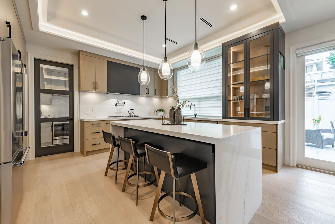 Kitchen with updated flooring and layered lighting